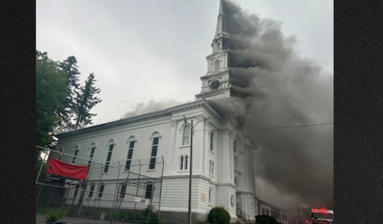 Smoke pours out of the historic First Congregational Church in Spencer, Massachusetts, Friday.