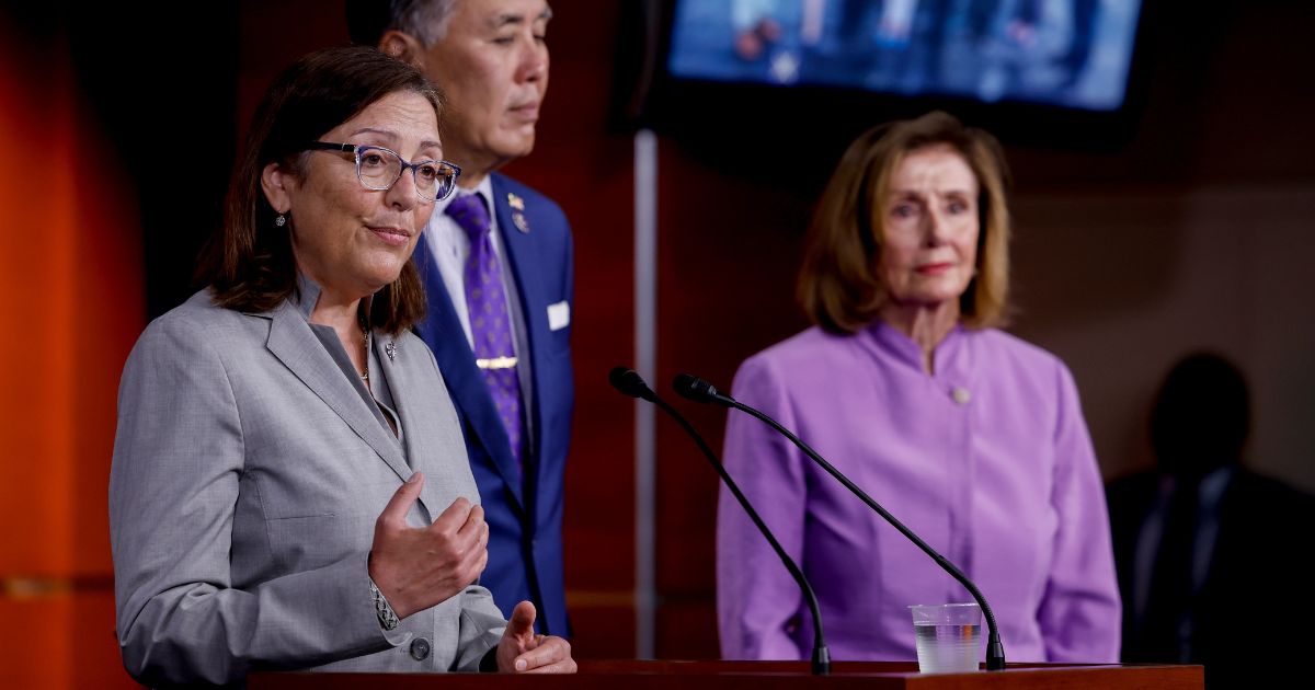Rep. Suzan DelBene of Washington, left, speaks while fellow Democratic Reps. Mark Takano and Nancy Pelosi, both of California, look on during a news conference at the U.S. Capitol in Washington on Aug. 10, 2022.