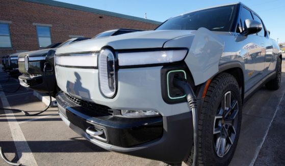 A 2023 R1T pickup truck is charged in a bay at a Rivian delivery and service center on Feb. 8 in Denver.