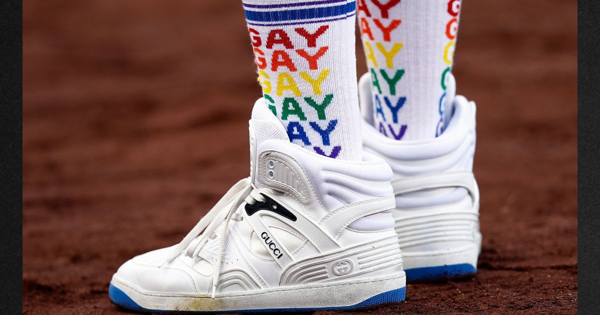 A baseball fan's "gay" socks are seen before a game between the New York Mets and the Los Angeles Dodgers on LGBTQ+ Pride Night at Dodger Stadium in June 2022. LGBT activists are questioning why the Texas Rangers are not hosting a "pride night."