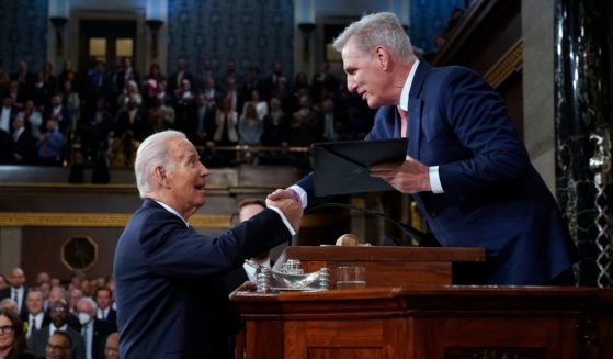 President Joe Biden and California House Speaker Kevin McCarthy shake hands as Biden presents a copy of his speech before delivering his State of the Union address to a joint session of Congress in the House Chamber of the Capitol in Washington on Feb. 7.