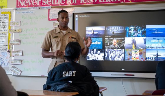 Lt. Kwazel Bertrand speaks to students during a Navy Promotional Day recruitment event at Abraham Lincoln High School in Philadelphia on May 9, 2022.