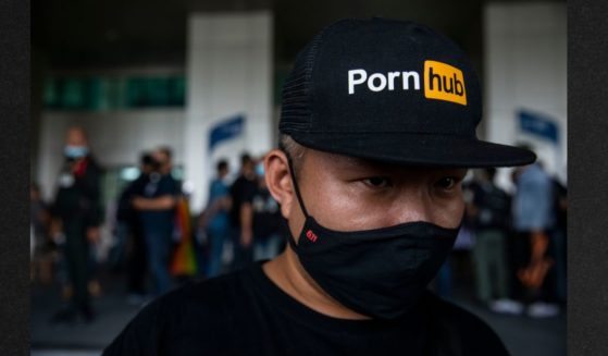 A Thai protester wears a Pornhub hat during a rally in Bangkok, Thailand, in a file photo from 2020. The pornography website announced it will block users in Virginia starting July 1 in response to a new law requiring verification that users are over 18.