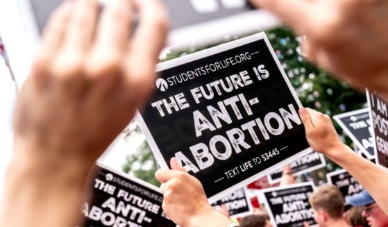 Pro-life activists hold signs outside the U.S. Supreme Court in Washington, D.C., on June 24, 2022.