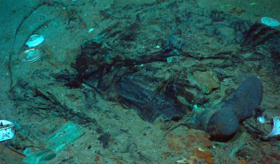 The remains of a coat and boots are seen in the mud on the sea bed near the Titanic's stern.
