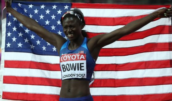 Tori Bowie holds the American flag after winning the 100m final at the 16th IAAF World Athletics Championships in London on Aug. 6, 2017.