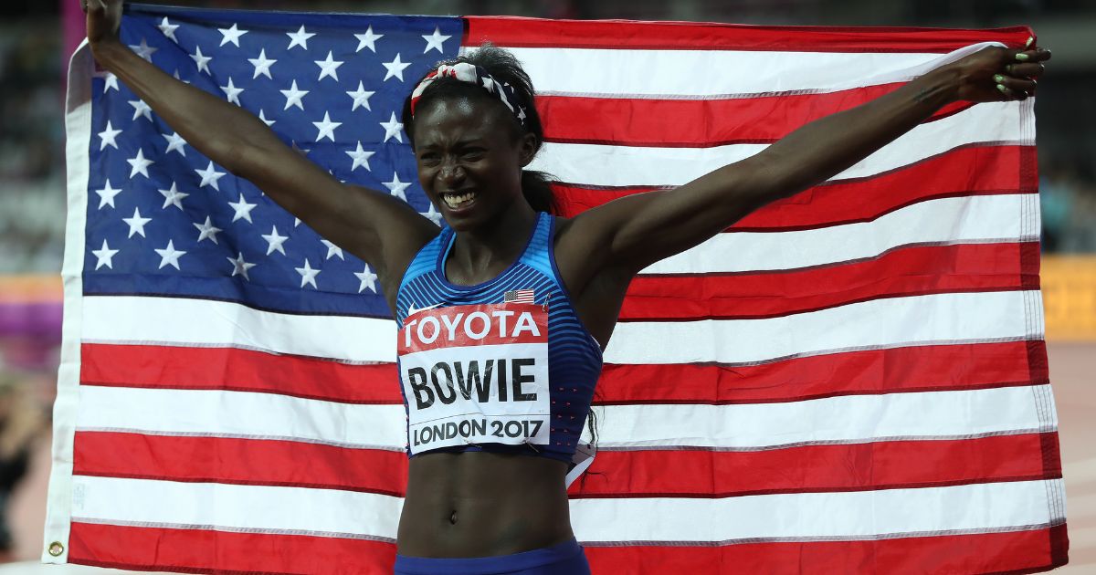 Tori Bowie holds the American flag after winning the 100m final at the 16th IAAF World Athletics Championships in London on Aug. 6, 2017.