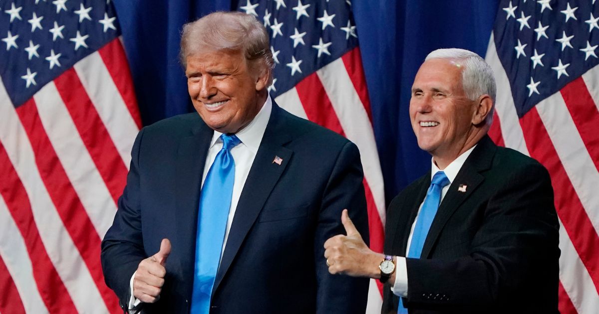 Then-President Donald Trump and his vice president, Mike Pence give a thumbs up after speaking on the first day of the Republican National Convention at the Charlotte Convention Center in North Carolina on Aug. 24, 2020.