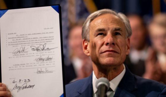 Texas Gov. Greg Abbott displays a bill he signed at a news conference at the state Capitol on June 8, 2023 in Austin, Texas.