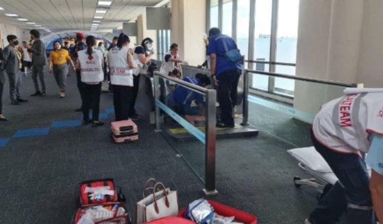 A woman had to have her left leg amputated after it became caught in an airport's moving walkway in Thailand.