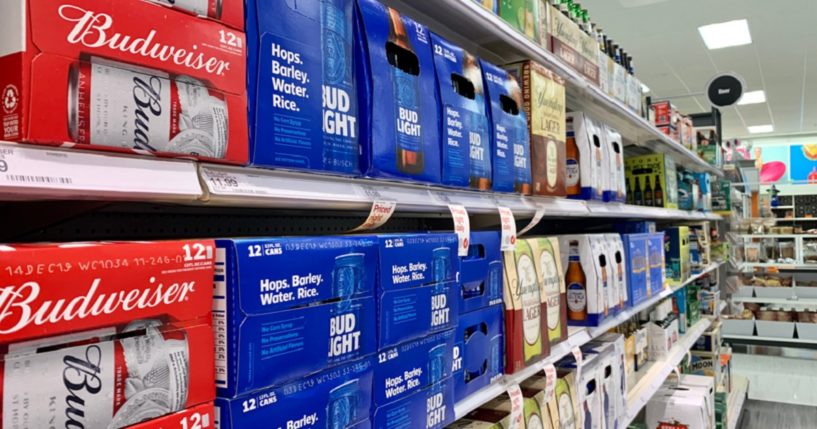 Budweiser and Bud Light, two of brewing giant Anheuser-Busch's best-selling brands, are pictured on a store shelf in a file photo from 2019.