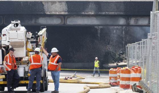 Officials work on the scene following a collapse on I-95 after a truck fire in Philadelphia on Sunday.