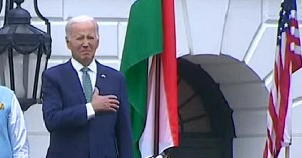President Joe Biden holds his hand over his heart Thursday as the national anthem is played at the White House.
