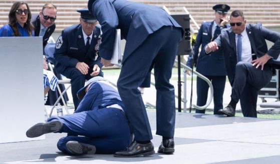 President Joe Biden is helped up after falling during the graduation ceremony at the United States Air Force Academy, just north of Colorado Springs in El Paso County, Colorado, on Thursday.