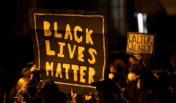 Demonstrators holding placards reading "BLACK LIVES MATTER" protest in October 2020 over in Philadelphia over the shooting of Walter Wallace Jr., a black man who was in a confrontation with police while armed with a knife.
