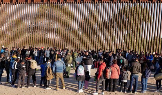 Migrants attempting to illegally enter the U.S. from Mexico are detained by U.S. Customs and Border Protection at the border on May 6 in San Luis, Arizona.