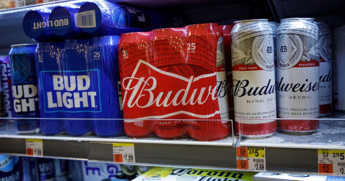 Cans of Budweiser and Bud Light sit on a shelf for sale at a convenience store, July 26, 2018, in New York City.