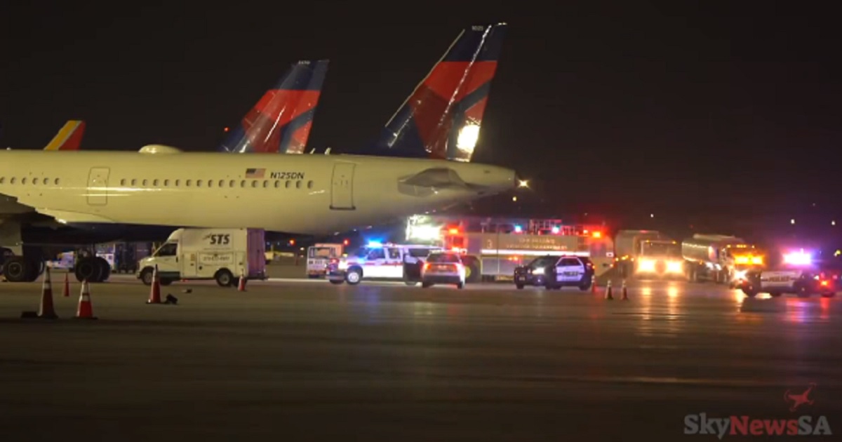 Emergency vehicles surround the Delta Airlines jet where a ground crew worker was killed Friday night in San Antonio, Texas.