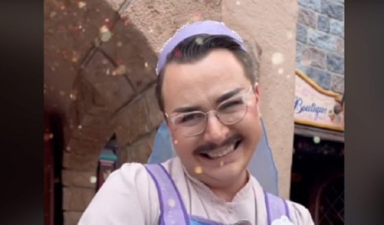 A mustachioed man dressed as a "fairy godmother's apprentice" beams in a picture from Disneyland in Anaheim, California.
