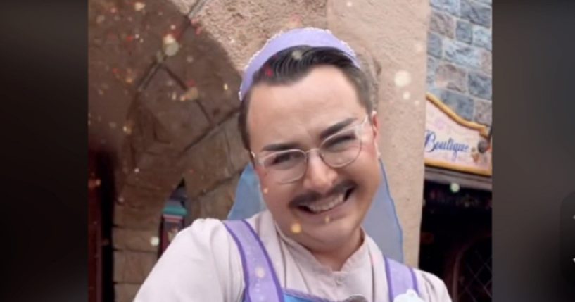 A mustachioed man dressed as a "fairy godmother's apprentice" beams in a picture from Disneyland in Anaheim, California.