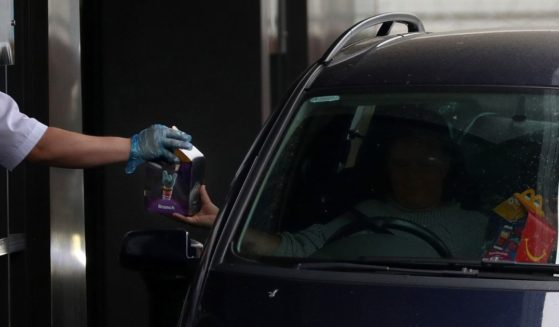 A member of the public receives his McDonald's Happy Meal order as the drive thru resumes trading on June 3, 2020 in Aylesbury, United Kingdom.