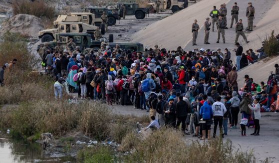 Texas National Guard troops block immigrants from entering a high-traffic border crossing area along Rio Grande in El Paso, Texas, on Dec. 20, 2022, as viewed from Ciudad Juarez, Mexico.