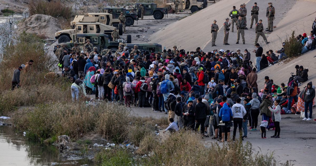 Texas National Guard troops block immigrants from entering a high-traffic border crossing area along Rio Grande in El Paso, Texas, on Dec. 20, 2022, as viewed from Ciudad Juarez, Mexico.