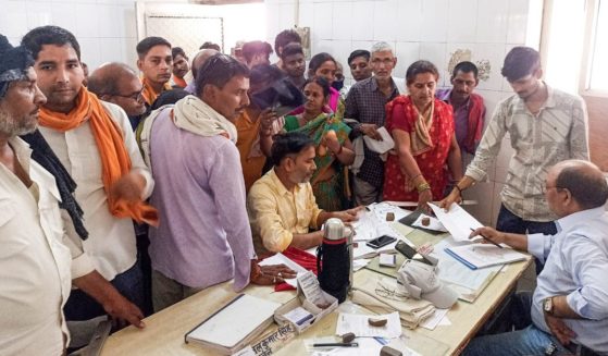 People crowd a hospital desk in Ballia district, in northern Uttar Pradesh state, India, on Sunday.