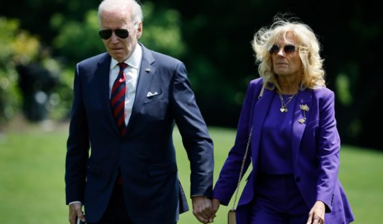 President Joe Biden and first lady Jill Biden walk across the South Lawn of the White House in a May file photo.