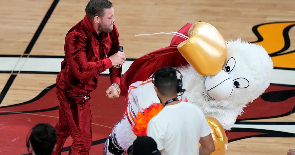 MMA fighter Conor McGregor punches Burnie, the Miami Heat mascot, during a break in Game 4 of the basketball NBA Finals in Miami on Friday.