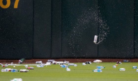 Oakland Athletics fans throw garbage onto the field after a reverse boycott game at RingCentral Coliseum on Tuesday in Oakland, California.
