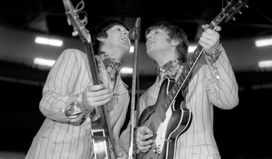 Musicians Paul McCartney and John Lennon perform onstage at Olympia Stadium in Detroit on Aug. 13, 1966.