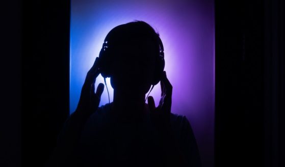 A person listens to music in this stock image.