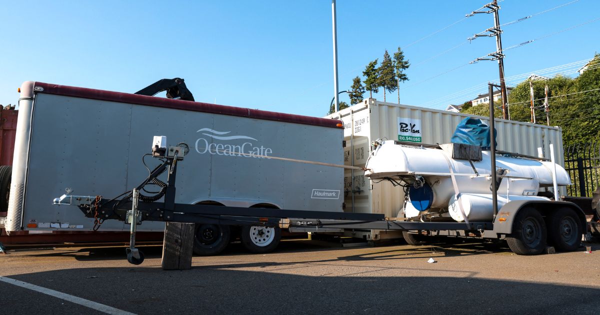 A trailer featuring the OceanGate logo is pictured near a trailer and other equipment at OceanGate Expedition's headqurters in the Port of Everett Boat Yard in Everett, Washington, on June 22, 2023.