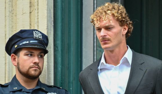 Daniel Penny is escorted in handcuffs by the NYPD after turning himself into the 5th Precinct on May 12 in New York City.