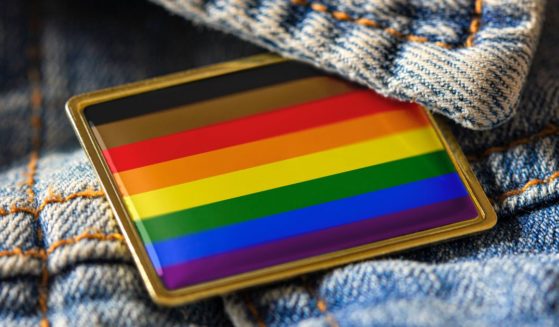 An LGBT pin is seen in this stock image.