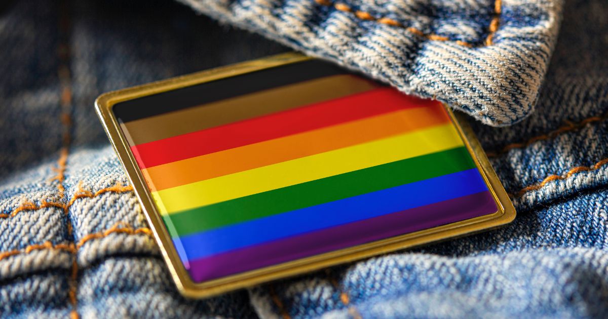 An LGBT pin is seen in this stock image.