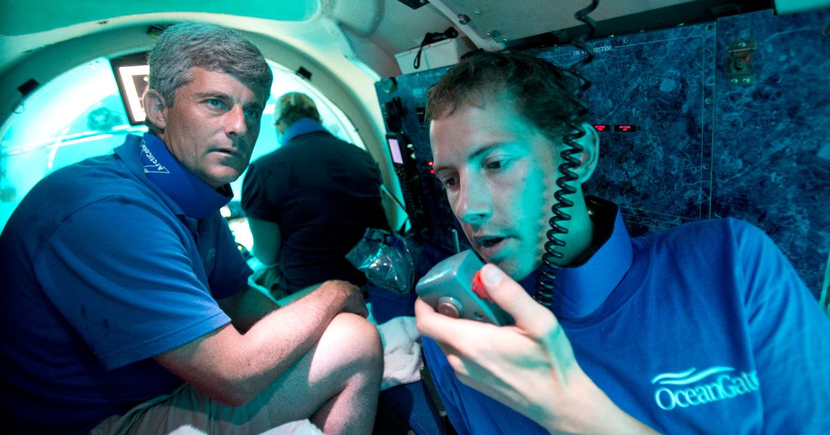 Submersible pilot Randy Holt, right, communicates with the support boat as he and Stockton Rush, left, CEO and co-founder of OceanGate, dive in the company's submersible, "Antipodes," about three miles off the coast of Fort Lauderdale, Florida, on June 28, 2013.