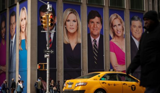 Advertisements featuring Fox News personalities, including Tucker Carlson, adorn the front of the News Corporation building, March 13, 2019 in New York City.