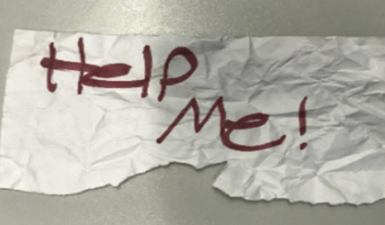 This undated photo shows a "help me" sign used by a 13-year-old girl kidnapped in Texas.