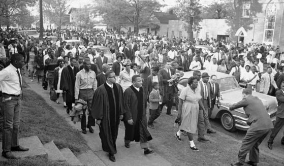 In this April 14, 1963 file photo, two ministers lead protest marchers in a civil rights demonstration in Birmingham, Ala., which was later broken up by police.