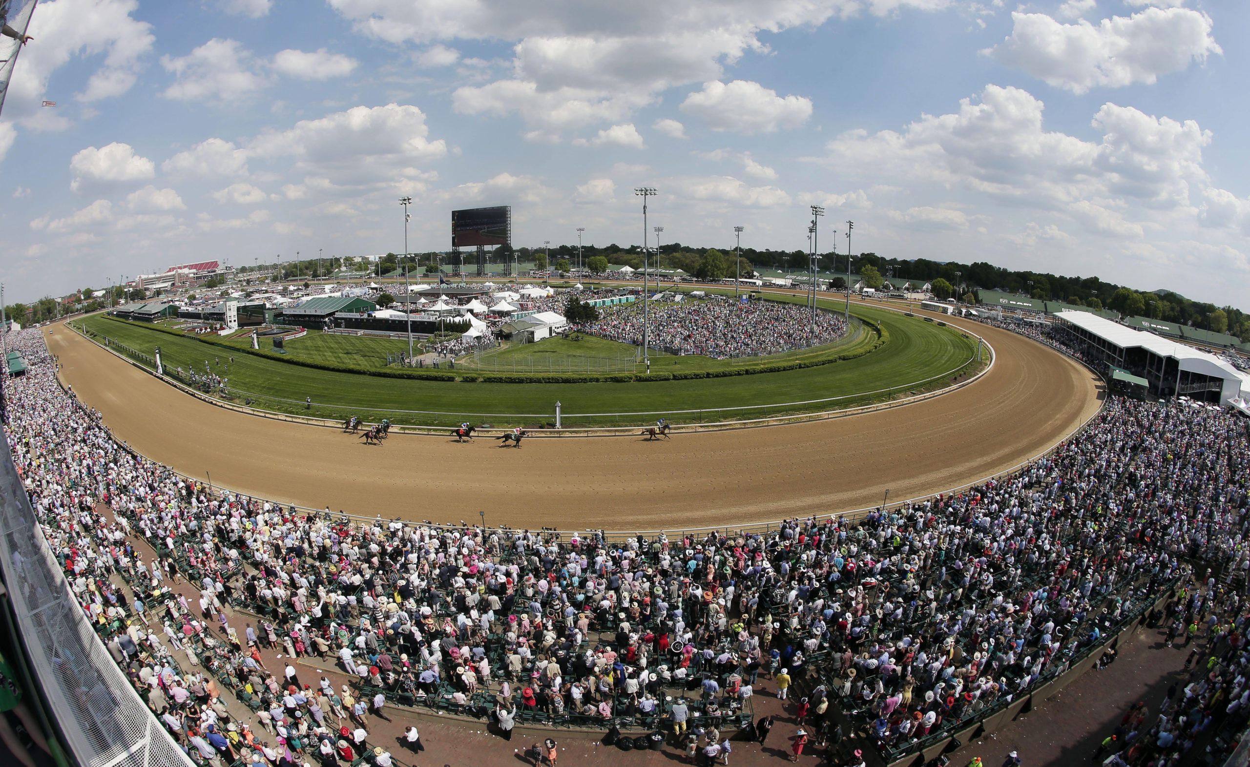 Fans watch a race before the 141st running of the Kentucky Derby horse race at Churchill Downs in Louisville, Kentucky, on May 2, 2015.
