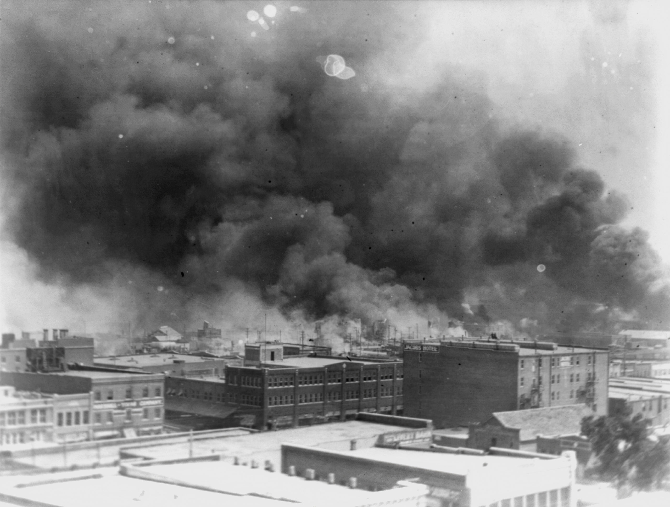 In this 1921 image, smoke billows over Tulsa, Oklahoma during the Tulsa Race Massacre.