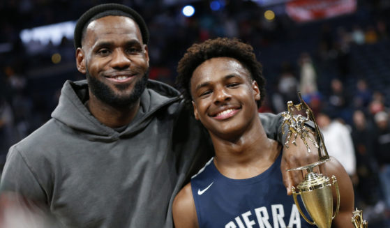 LeBron James, left, poses with his son Bronny after Sierra Canyon beat Akron St. Vincent-St. Mary in a high school basketball game on Dec. 14, 2019, in Columbus, Ohio.