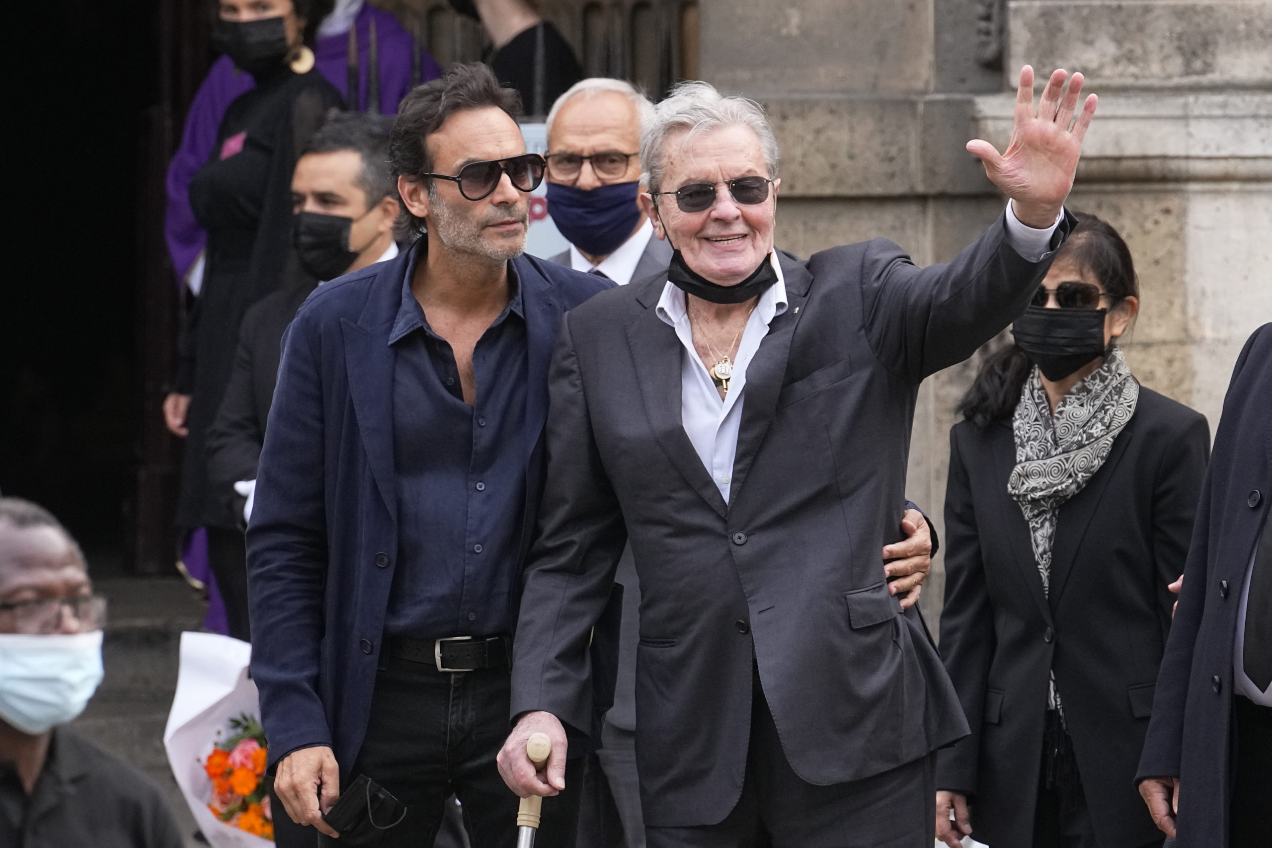 French actor Alain Delon and his son Anthony Delon, left, are seen in a file photo from September. Alain Delon's children are accusing his partner of bullying the 87-year-old French film star and of cruelty toward his dog — legal complaints that a French prosecutor has now directed police to investigate.