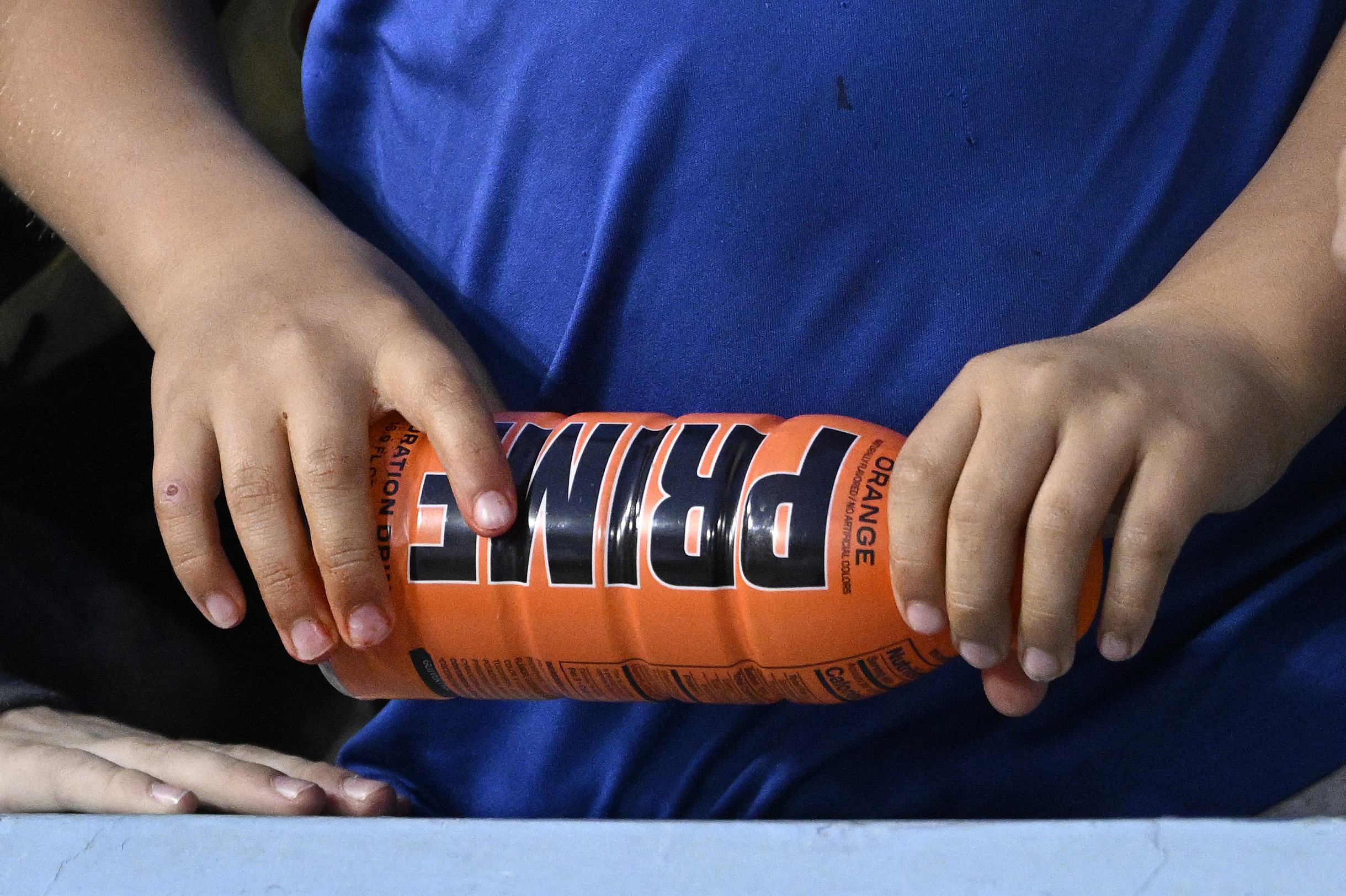 A child holds a PRIME hydration drink prior to a baseball game between the Los Angeles Dodgers and the Arizona Diamondbacks in Los Angeles on March 31.