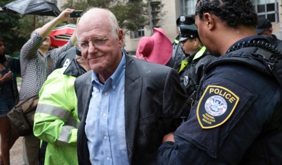Ben Cohen, co-founder of Ben & Jerry’s ice cream, is arrested outside the Department of Justice on Thursday in Washington, D.C.