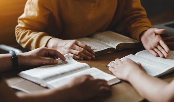 This stock photo shows a group doing a Bible study together.