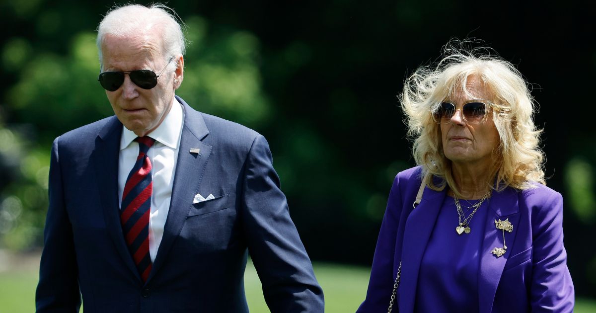 President Joe Biden and first lady Jill Biden walk across the South Lawn of the White House on May 15.