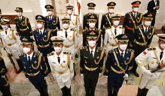 Members of a military honor guard stand in the Great Hall of the People on June 26 in Beijing.